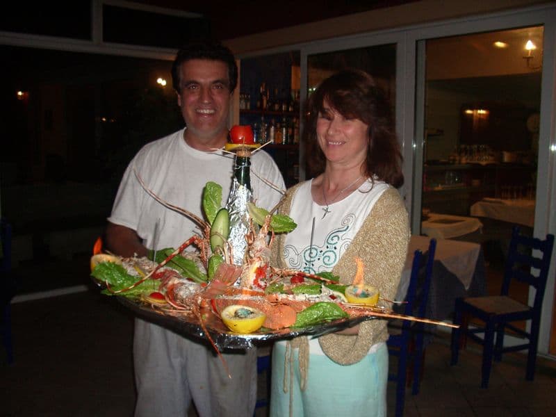 Dimitris and Yanna holding a platter of lobster and langoustines in the early years of Bacchus