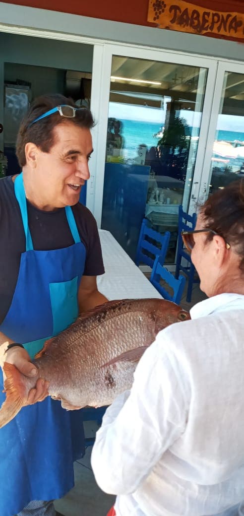 Dimitris · showing a guest the morning's catch